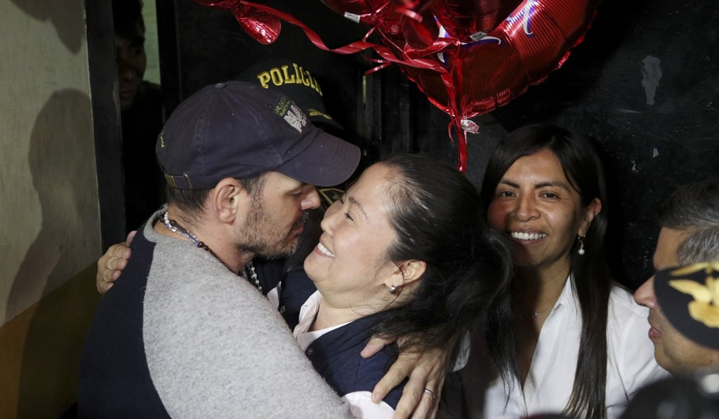 Keiko Fujimori embraces her husband, Mark Vito Villanela, after walking out from prison. Photo: AP