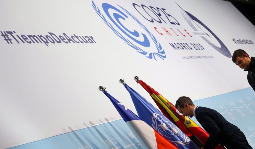 A worker sets up flags at IFEMA Convention Centre ahead of the 2019 UN climate change conference. Photo: Reuters
