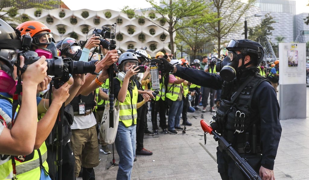 An officer aims pepper spray at a group appearing to comprise only journalists, on another day in Hong Kong when officers repeatedly relied on riot control agents when faced with protests. Photo: Sam Tsang