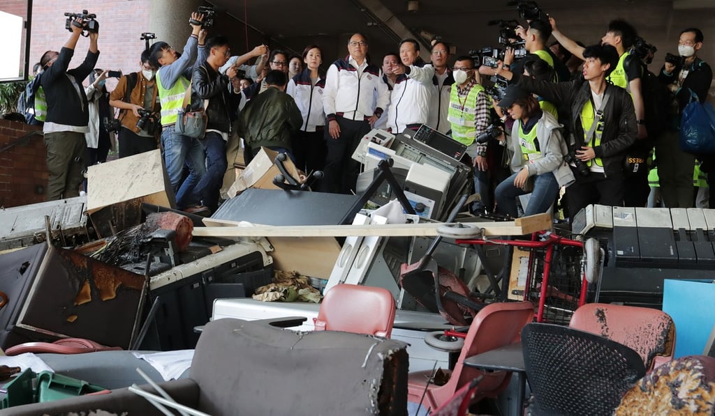 Lam Tai-fai (centre), Polytechnic University council chairman, visits the campus in Hung Hom to survey the damage. Photo: Edmond So