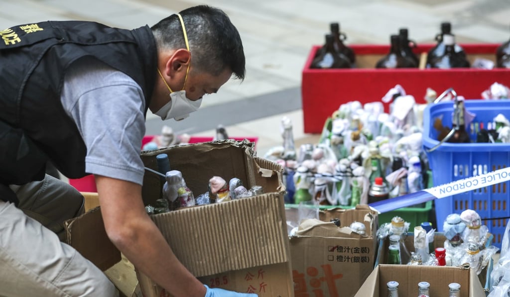 A police officer removes a box of hazardous items from Polytechnic University. Photo: Sam Tsang