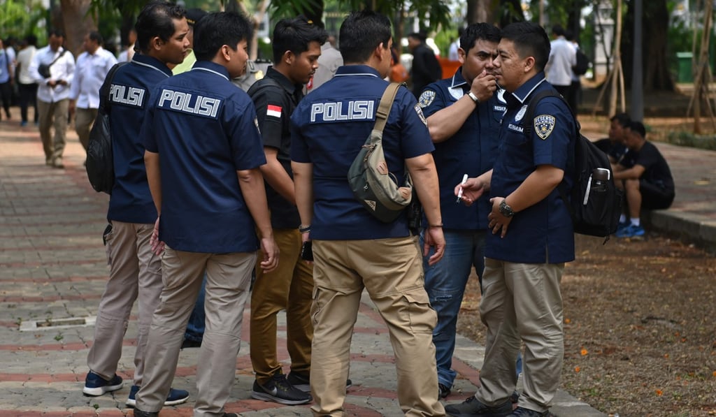 Indonesian police next to the blast site in Jakarta. Photo: AFP