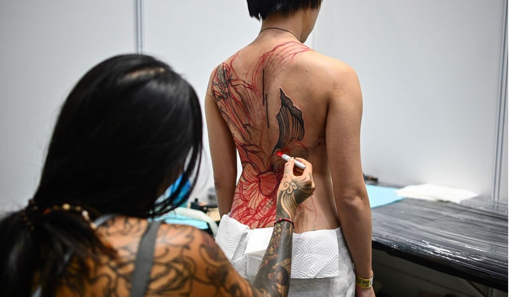 A tattoo artist works on a client during the International Malaysia Tattoo Expo in Kuala Lumpur. Photo: AFP