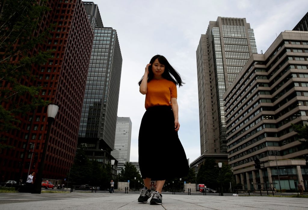 Ishikawa walks through a business district in Tokyo, Japan. Photo: Reuters