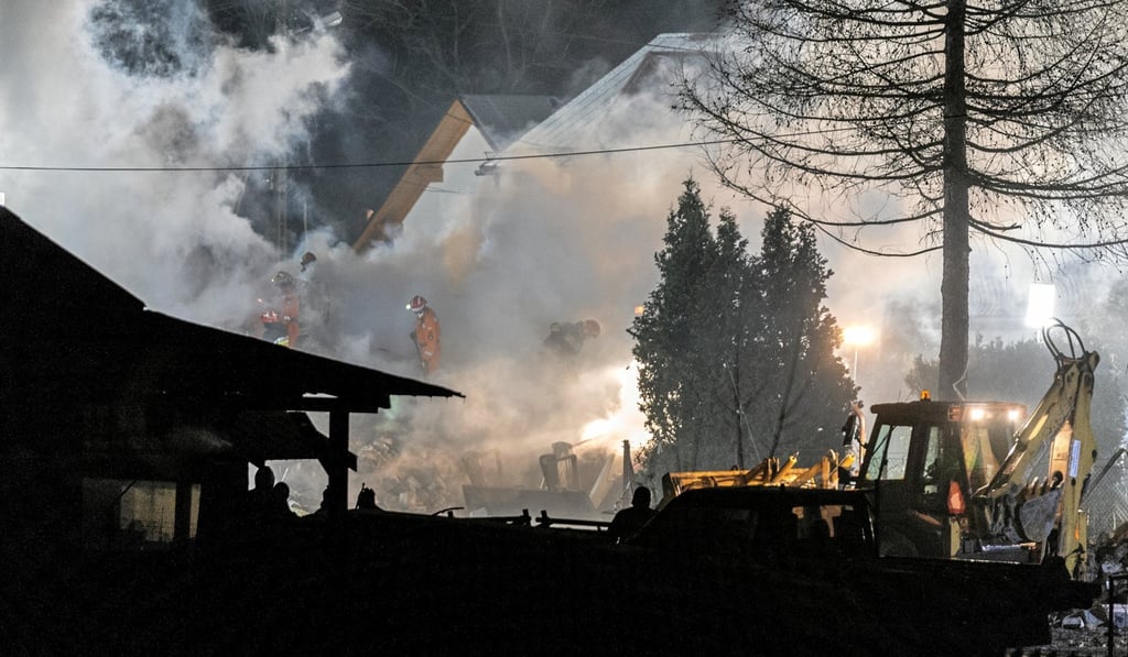 Firefighters work at the site of a building levelled by a gas explosion in Szczyrk. Photo: Handout via Reuters