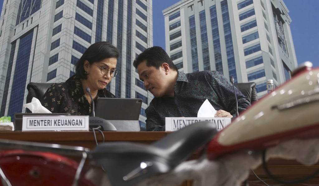 Indonesian Finance Minister Sri Mulyani Indrawati, left, confers with Minister of State-Owned Enterprises Eric Thohir. Photo: AP Indonesian Finance Minister Sri Mulyani Indrawati, left, confers with Minister of State-Owned Enterprises Eric Thohir. Photo: AP