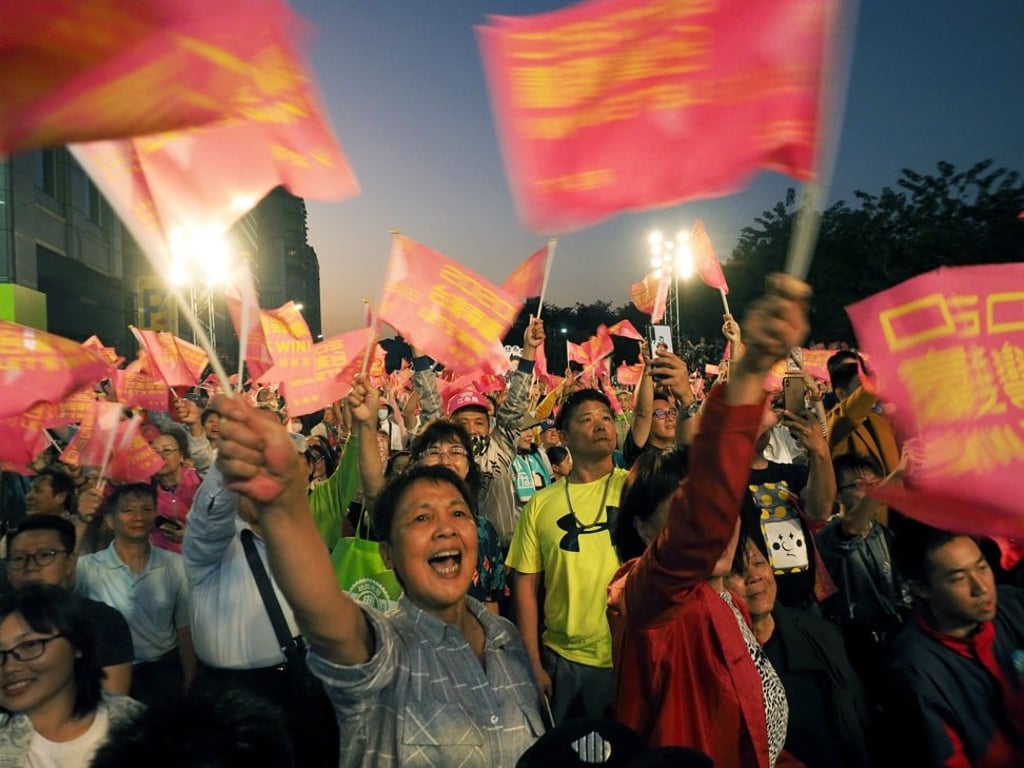 People wave flags at a campaign rally of Taiwanese President Tsai Ing-wen in Taipei on November 17. Her re-election at the presidential polls in January next year appears certain. Photo: EPA-EFE