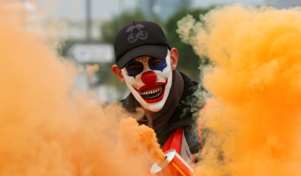 A protester wearing a mask is seen as French Labour union members demonstrate against pension reform plans in Marseille on Thursday. Photo: Reuters A protester wearing a mask is seen as French Labour union members demonstrate against pension reform plans in Marseille on Thursday. Photo: Reuters