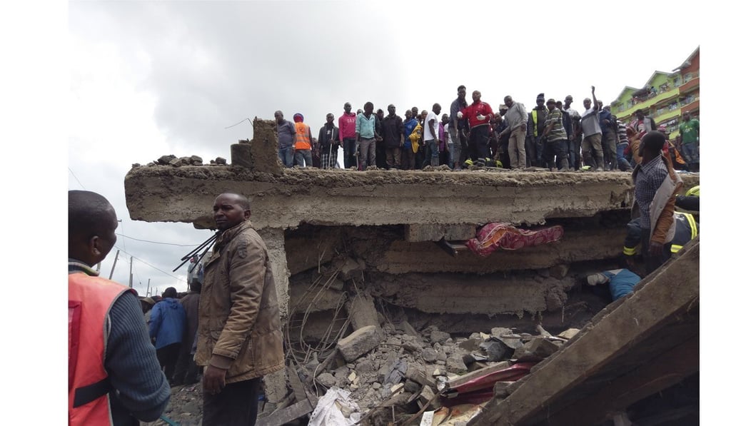 People stand on top of a collapsed six-storey building in Nairobi, Kenya. Photo: EPA-EFE People stand on top of a collapsed six-storey building in Nairobi, Kenya. Photo: EPA-EFE