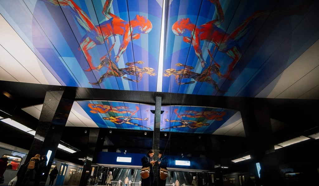 Commuters walk at CSKA /TSSKA/ metro station, with its ceiling decorated with images of runners, in Moscow. Photo: AFP Commuters walk at CSKA /TSSKA/ metro station, with its ceiling decorated with images of runners, in Moscow. Photo: AFP