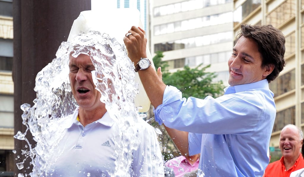 Canadian Liberal leader and eventual prime minister Justin Trudeau dumps a bucket of ice water on Liberal MP Sean Casey in Edmonton, Canada, in August 2014. Photo: Reuters