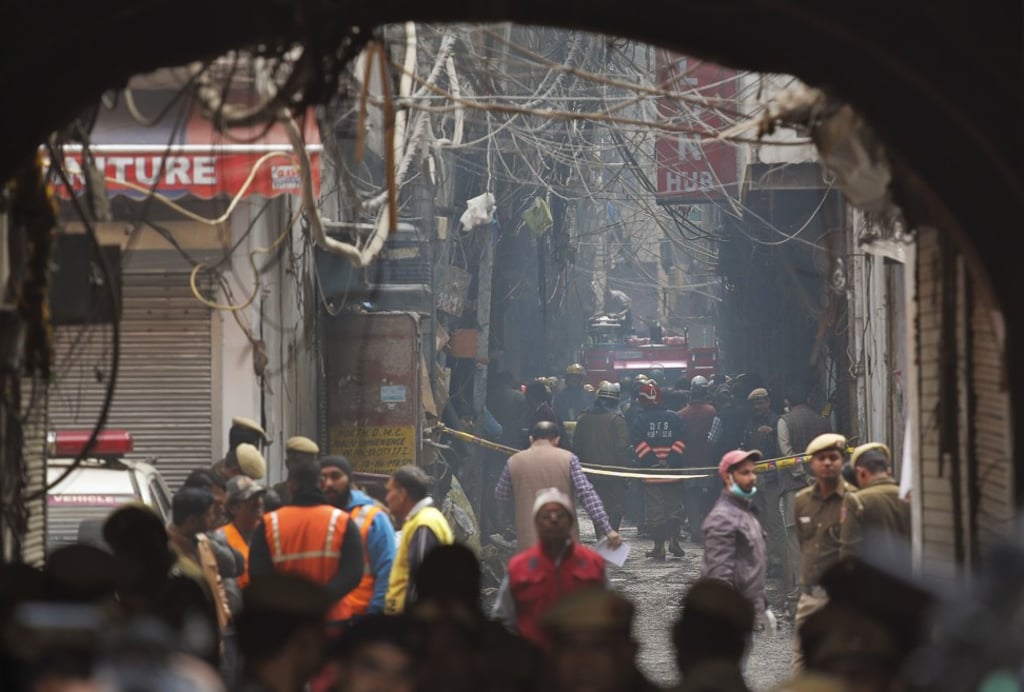 A fire engine stands by the site of a fire in an alleyway. Photo: AP A fire engine stands by the site of a fire in an alleyway. Photo: AP