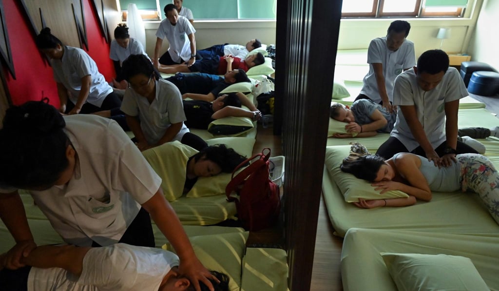 Tourists at the Wat Po Thai traditional massage centre on December 3, 2019, in Bangkok. Photo: AFP Tourists at the Wat Po Thai traditional massage centre on December 3, 2019, in Bangkok. Photo: AFP