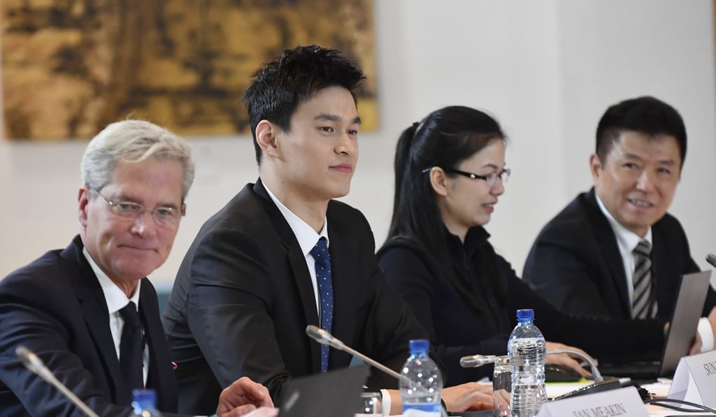 Sun Yang and his lawyers during the public hearing. Photo: Xinhua