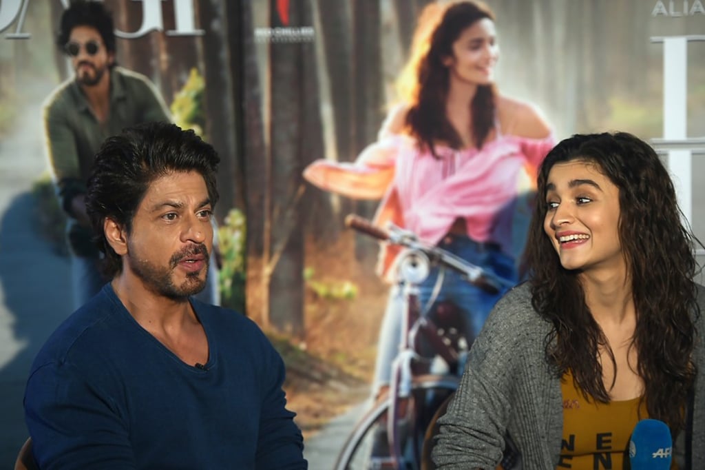 Bollywood actor Shah Rukh Khan speaks as actress Alia Bhatt looks on during an interview in Mumbai. Photo: Punit Paranjpe/Agence France-Presse
