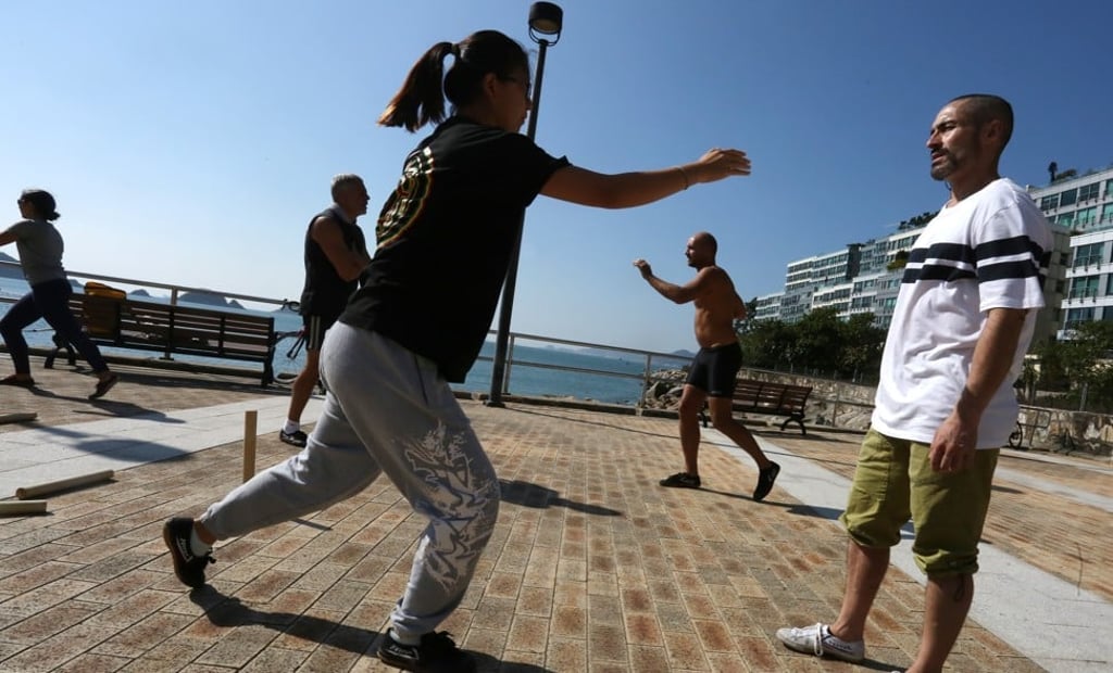 Movement culture coach Andres Vesga (right) leads a class at Repulse Bay Beach in Hong Kong. Photo: Jonathan Wong