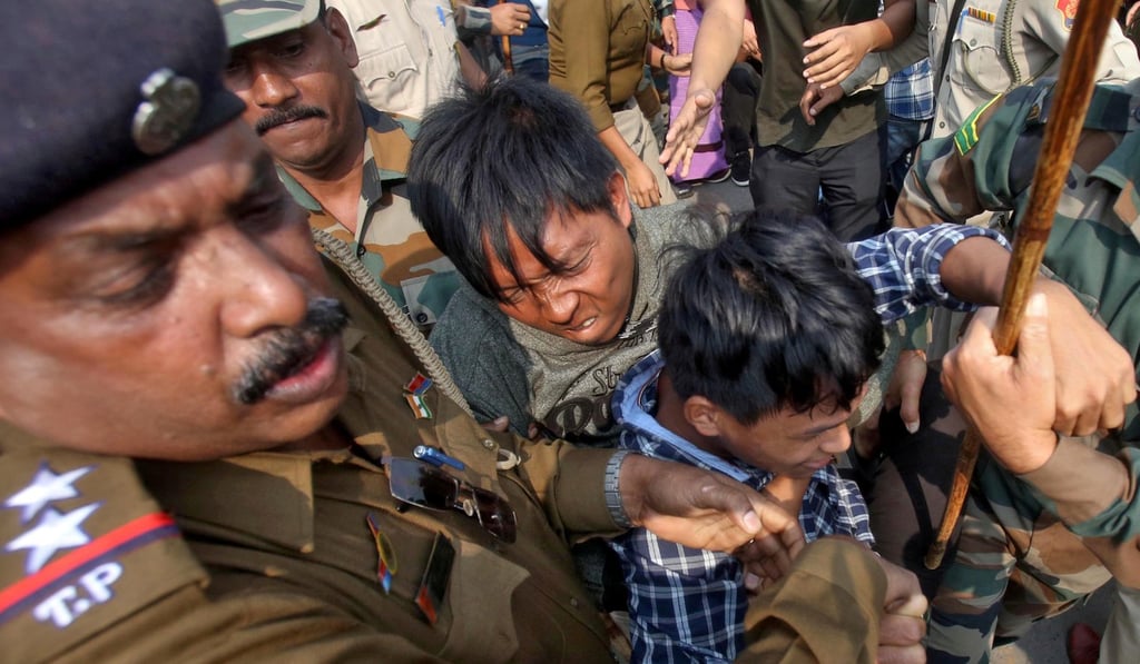 Police officers try to detain demonstrators during a protest against the Citizenship Amendment Bill. Photo: Reuters Police officers try to detain demonstrators during a protest against the Citizenship Amendment Bill. Photo: Reuters