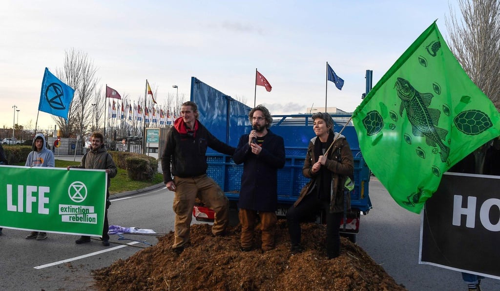 Activists from international climate action group Extinction Rebellion protest after dumping manure outside the UN Climate Change Conference COP25. Photo: AFP Activists from international climate action group Extinction Rebellion protest after dumping manure outside the UN Climate Change Conference COP25. Photo: AFP