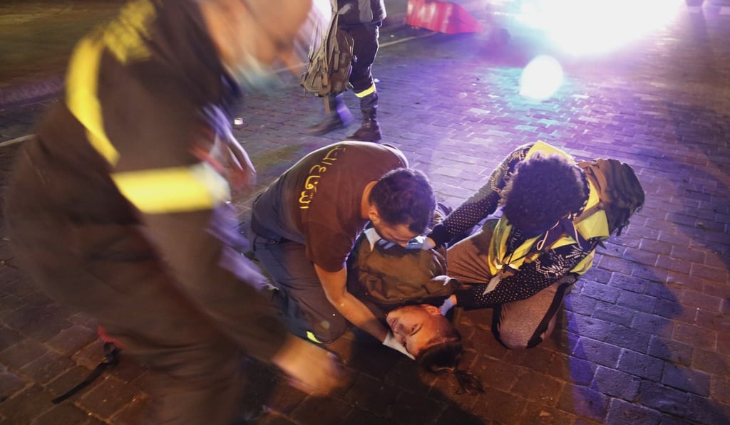 Civil defence workers treat a protester injured during a clash with riot police. Photo: AP Photo