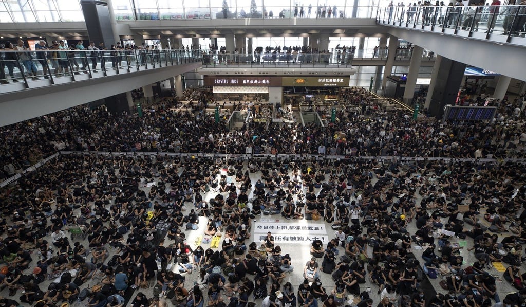 Anti-government protesters staged a sit-in at the arrival hall of Hong Kong International Airport in August. Photo: AP Anti-government protesters staged a sit-in at the arrival hall of Hong Kong International Airport in August. Photo: AP