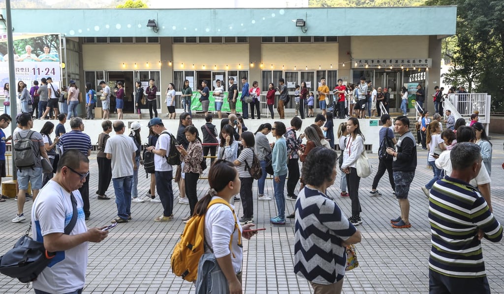 People queue up to vote in the district council elections. Photo: Winson Wong