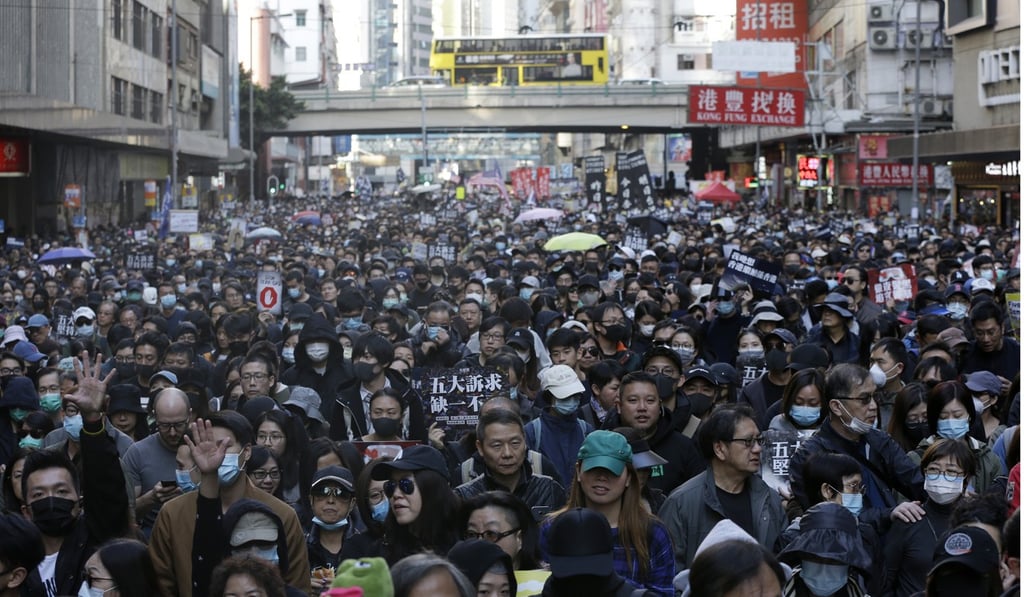 Thousands of protesters march in central Hong Kong on December 8, six months after the first protests began. Photo: AP Thousands of protesters march in central Hong Kong on December 8, six months after the first protests began. Photo: AP