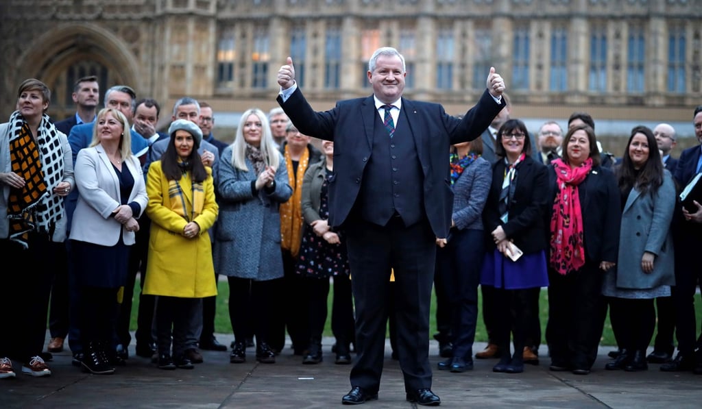 Scottish National Party Westminster leader Ian Blackford celebrates with party members following their general election win. Photo: AFP