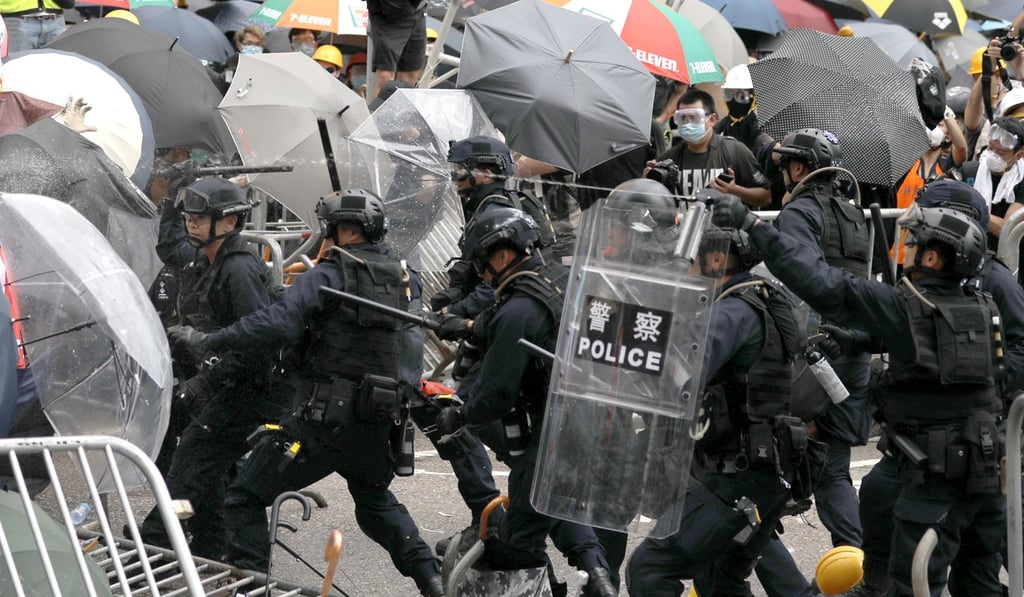 Riot officers use pepper spray to disperse crowds outside Legco on June 12. Photo: Sam Tsang