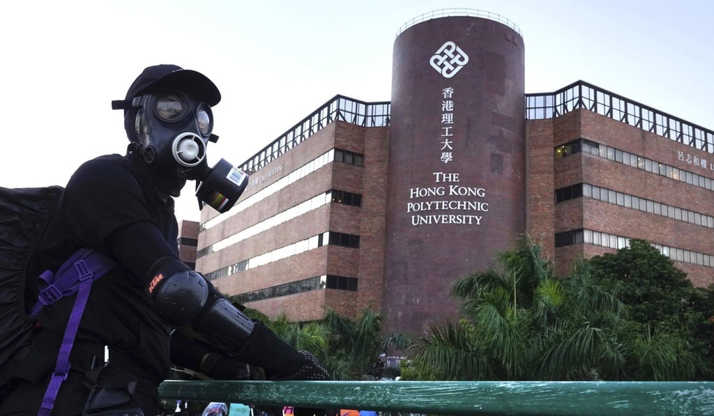 A protester stands on a bridge near Polytechnic University. Photo: AP