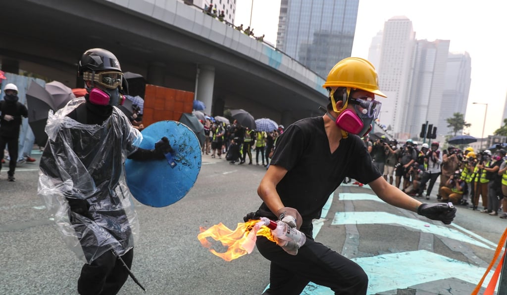 An anti-government protester gets ready to throw a petrol bomb at police during an illegal march in Hong Kong. Photo: Sam Tsang