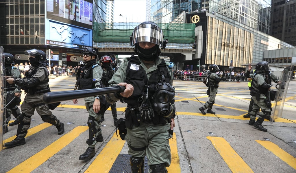 Riot police push back against protesters holding a lunchtime rally in Central. Photo: Xiaomei Chen