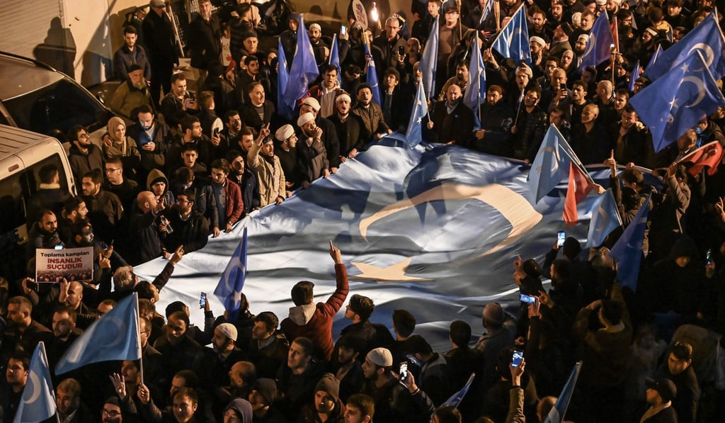 Protesters march with East Turkestan flags during a demonstration at Fatih in Istanbul on Friday. Photo: AFP