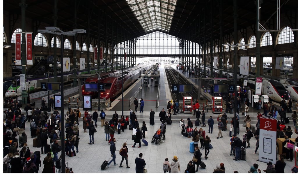 People stand in the hall of the Gare du Nord railway station in Paris, where many trains are not running. Photo: AP People stand in the hall of the Gare du Nord railway station in Paris, where many trains are not running. Photo: AP