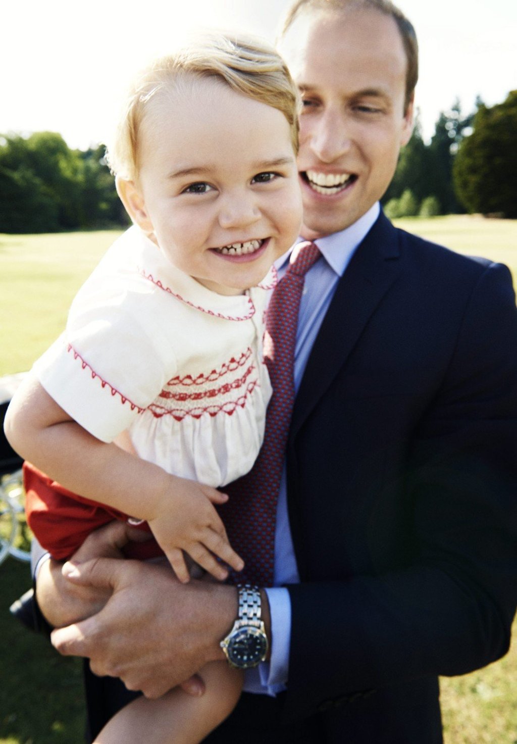 Prince William carries his son Prince George during his sister’s christening in July 2015. Photo: Handout