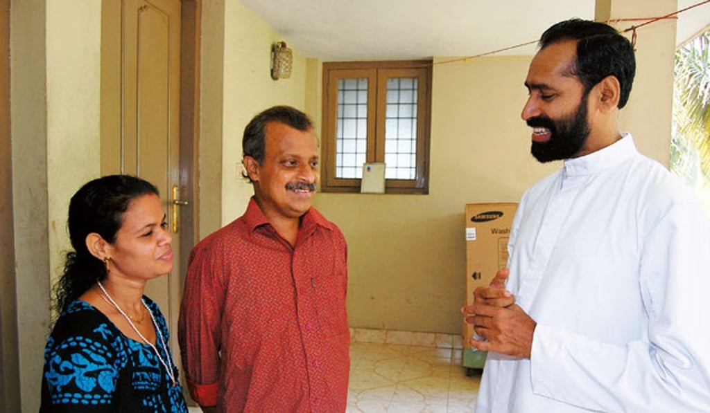 Reverend Father Davis Chiramel (right) with Gopinathan Chakkamadathil and his wife, Anita, after his donation of a kidney to the ailing electrician in 2009.