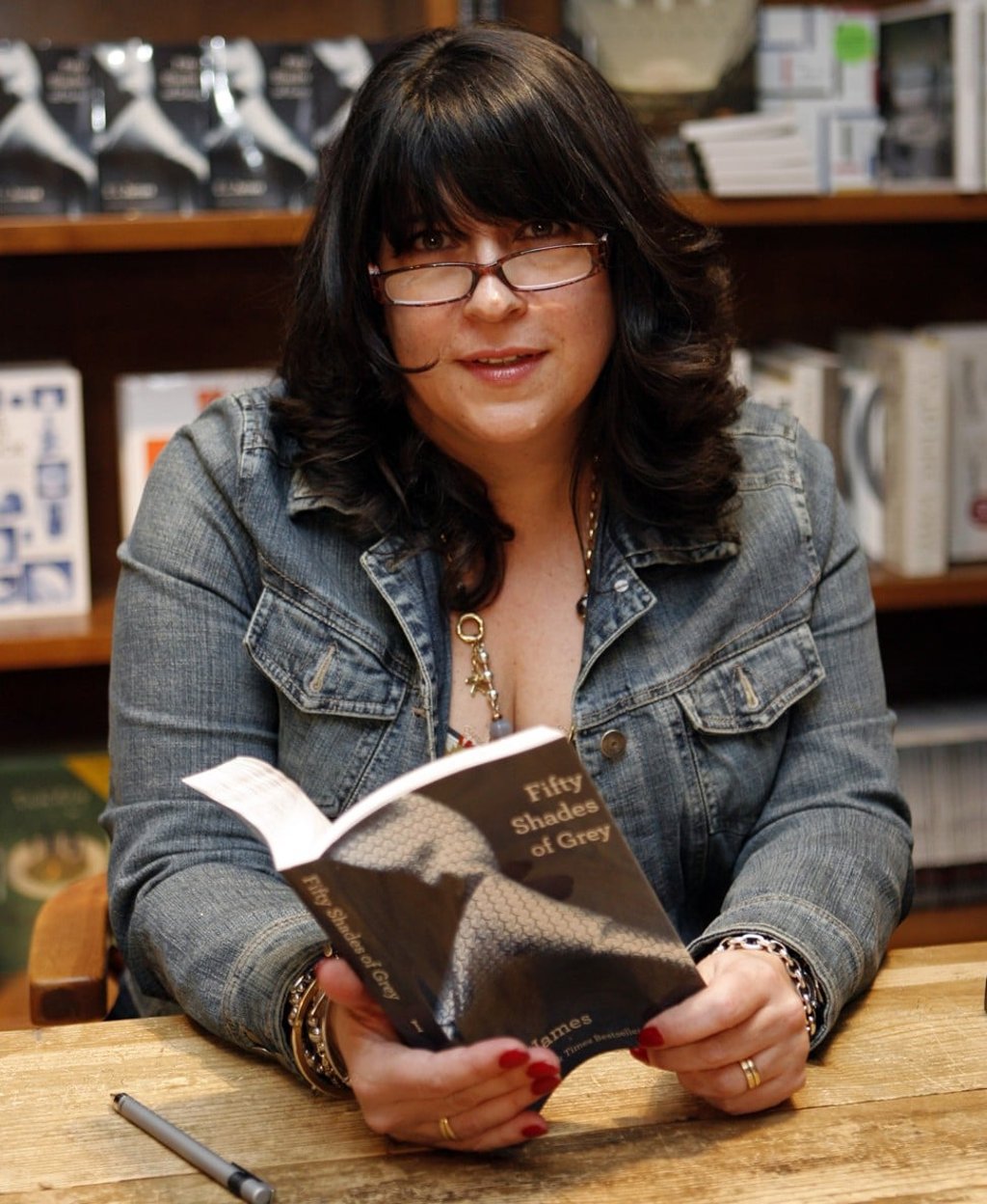 Author E L James holds a copy of Fifty Shades of Grey at a book signing in Florida, in the United States, in 2012. Photo: AP