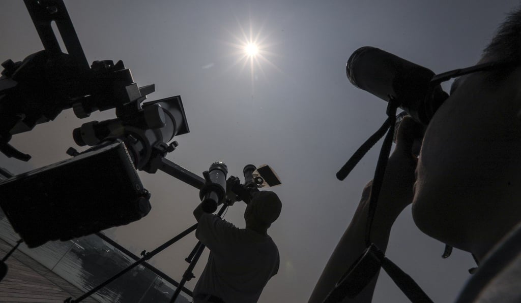 People used filters, telescopes and cameras to watch and capture images of the partial solar eclipse. Photo: Felix Wong
