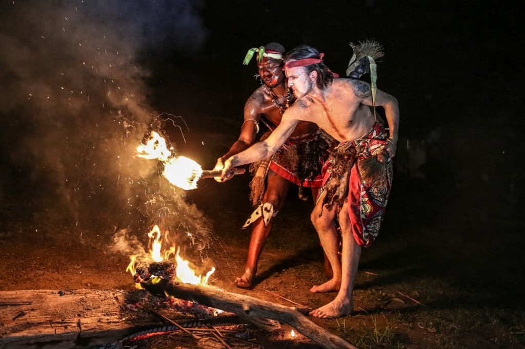 A British man lights a torch during a Bwiti tribal initiation rite in Libreville, Gabon, in which the iboga plant is used. Photo: AFP A British man lights a torch during a Bwiti tribal initiation rite in Libreville, Gabon, in which the iboga plant is used. Photo: AFP