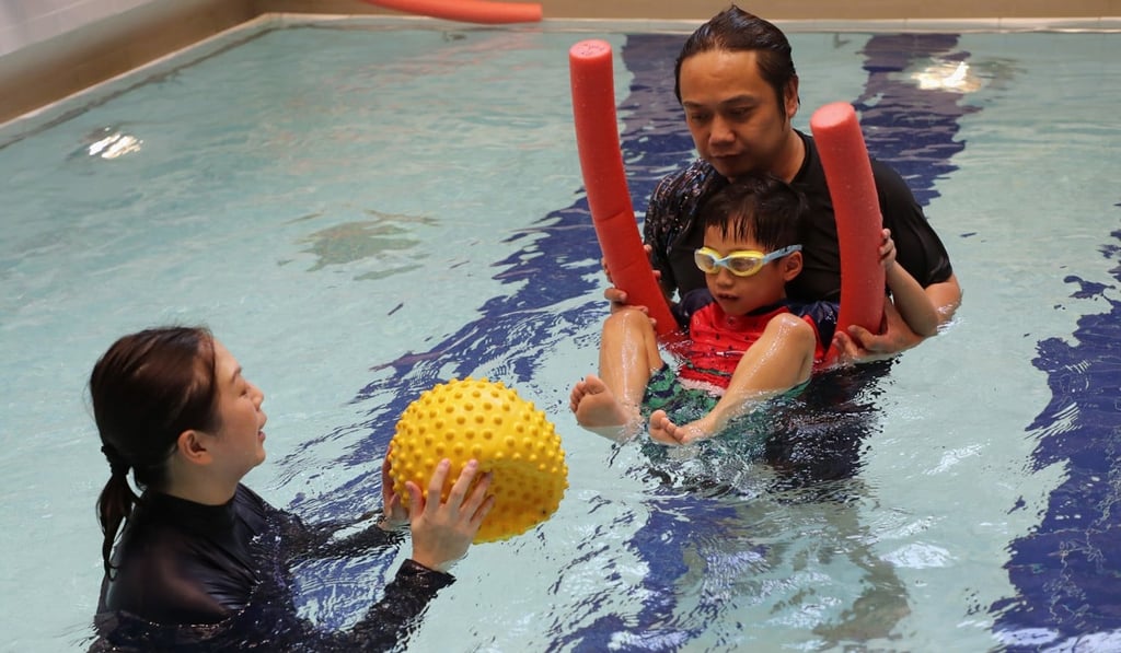 Lucas Mak and his father, Leo Mak, at a hydrotherapy session for children with special educational needs on October 21. Photo: Edward Wong