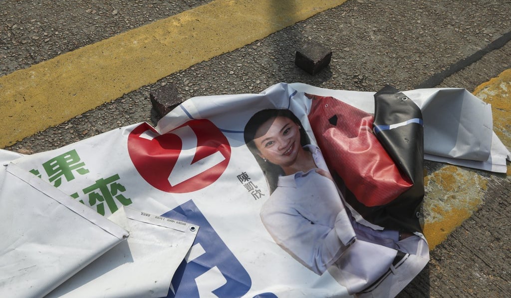The election banner of a pro-establishment lawmaker lies on the street after being torn down by anti-government protesters, in Kowloon Tong on November 14. Photo: Xiaomei Chen