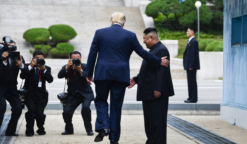 US President Donald Trump steps into the northern side of the Military Demarcation Line that divides North and South Korea. Photo: AFP
