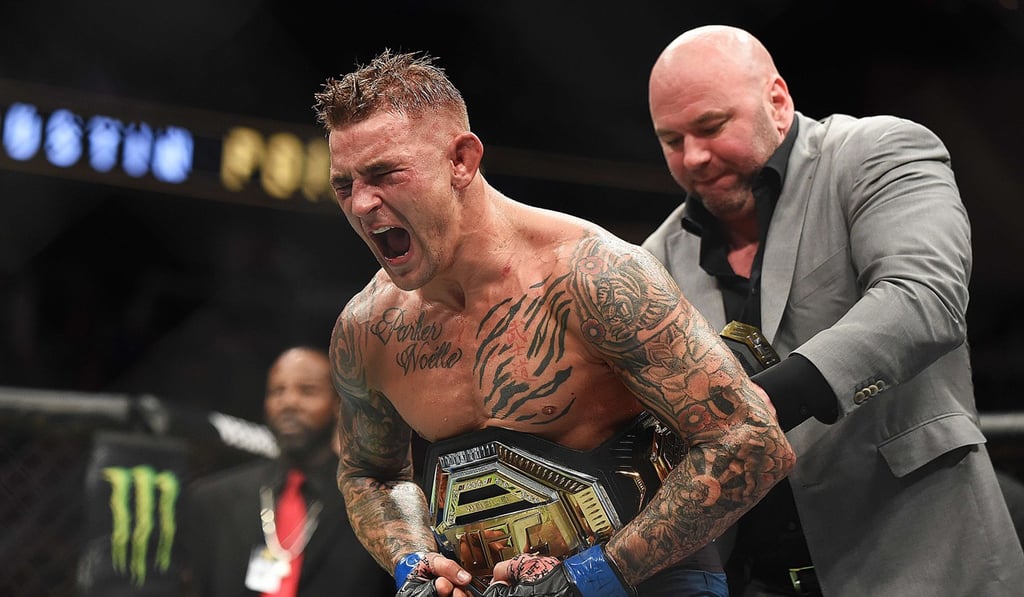 Dustin Poirier celebrates after winning the interim lightweight title belt against Max Holloway in April. Photo: AFP