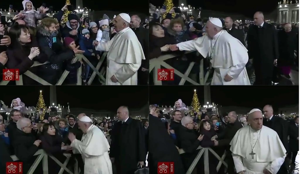 Pope Francis apologised for slapping on the hands of the woman in the image who had grabbed his arm as he greeted Catholic faithful on New Year's Eve. Photo: AFP