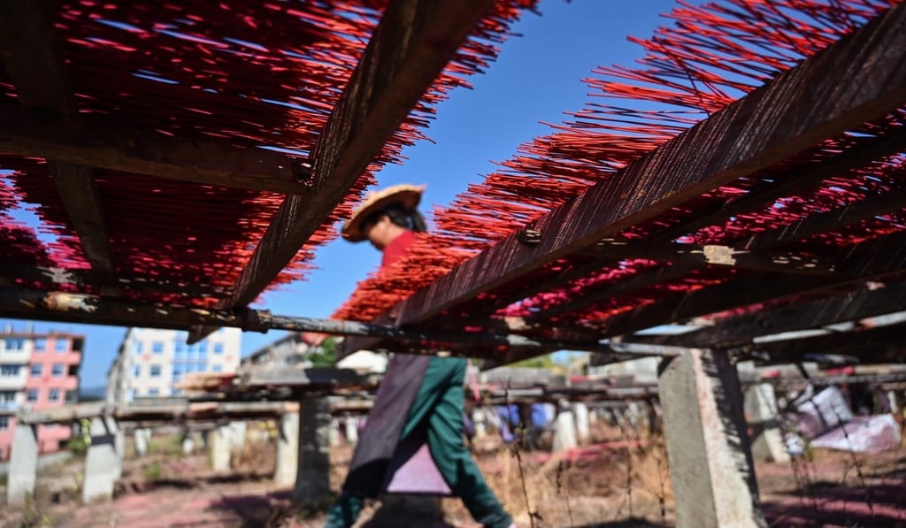 Incense sticks dry on wooden platforms at a factory in Quanzhou, Fujian province. Photo: AFP
