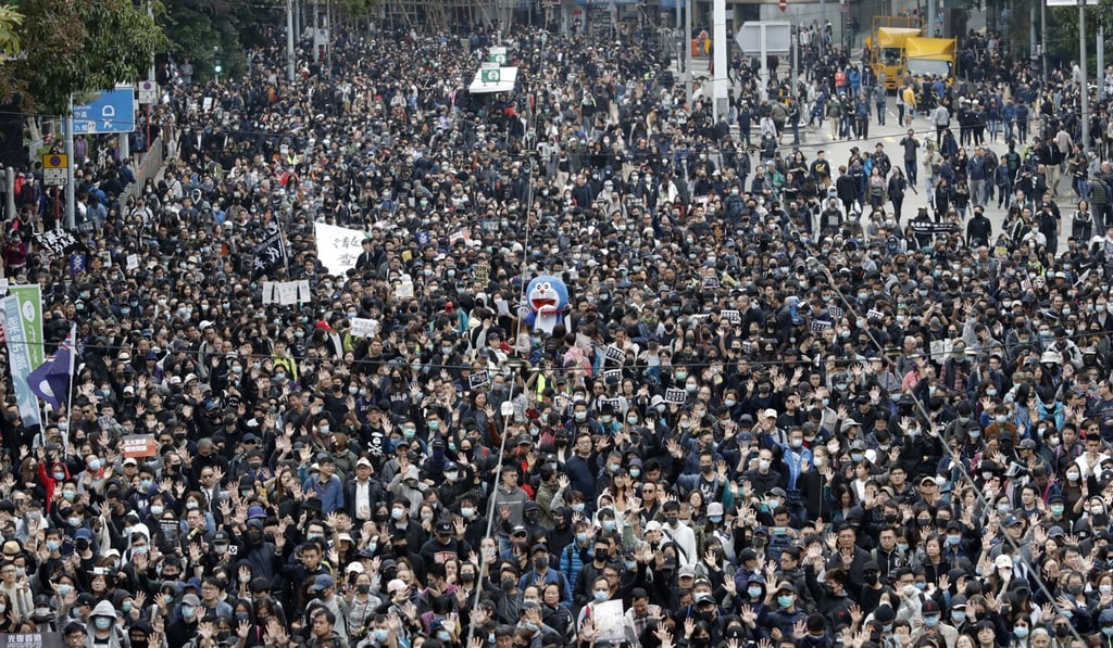 Protesters raise their hands to symbolise the five demands of the pro-democracy movement in Hong Kong during a rally on New Year’s Day 2020. Photo: AP