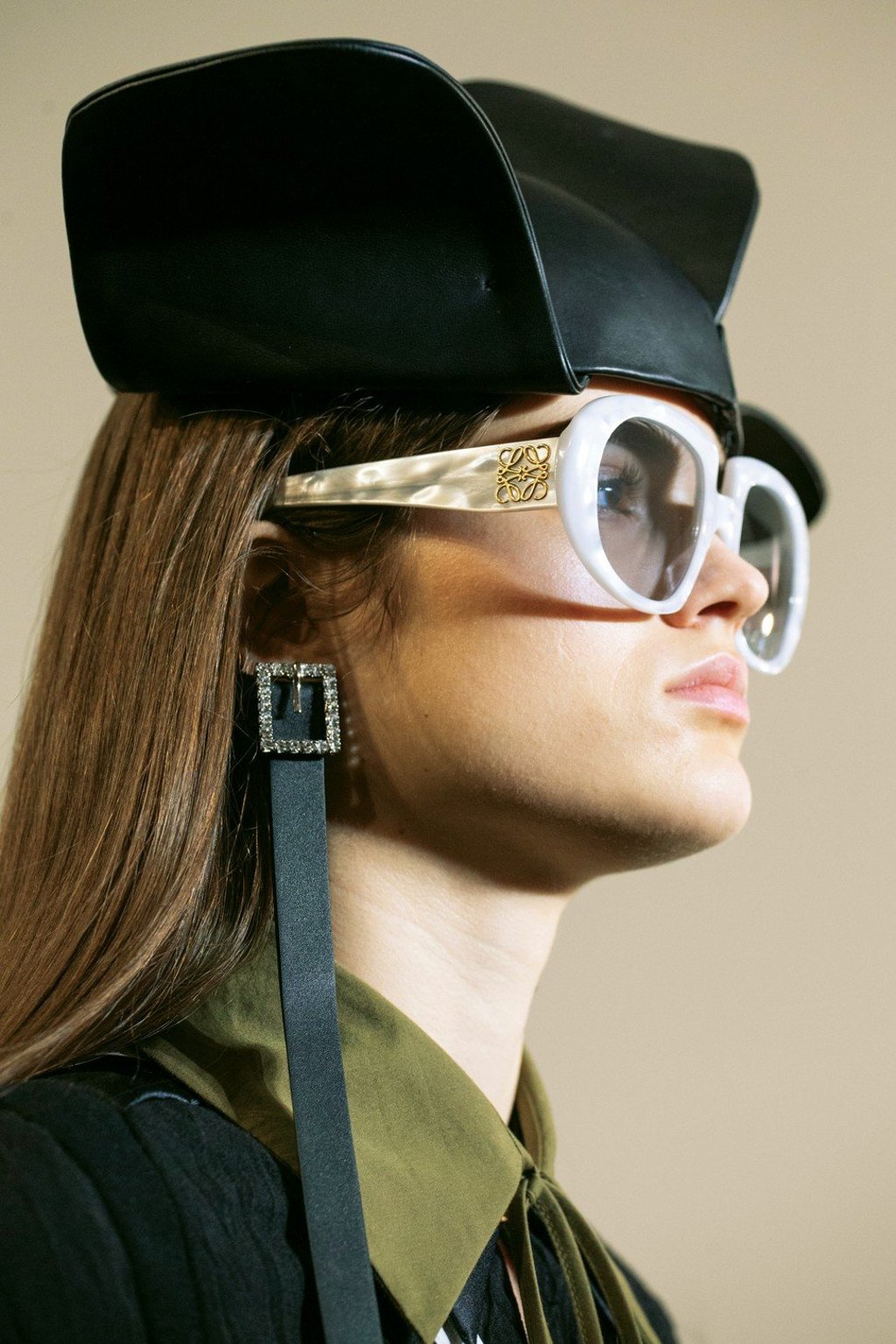 Loewe, a long belt earrings with a square crystal buckle waved in the air. Photo: Handout Loewe, a long belt earrings with a square crystal buckle waved in the air. Photo: Handout