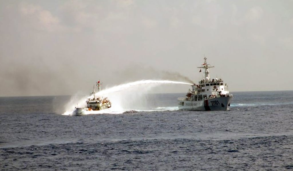 A photo released by Vietnam's coastguard showing a Chinese vessel using water cannons on a Vietnamese one near the Paracel Islands. Photo: EPA