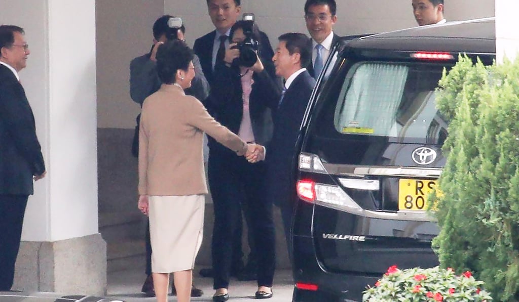 Luo Huining and Carrie Lam shake hands as Beijing’s top representative in Hong Kong arrives at Government House on Thursday. Photo: Winson Wong