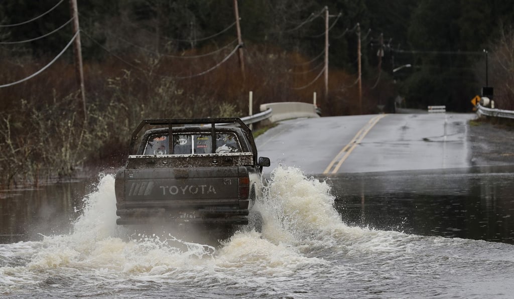 A truck drives through a flooded roadway near Littlerock, Washington. Photo: AP Photo A truck drives through a flooded roadway near Littlerock, Washington. Photo: AP Photo