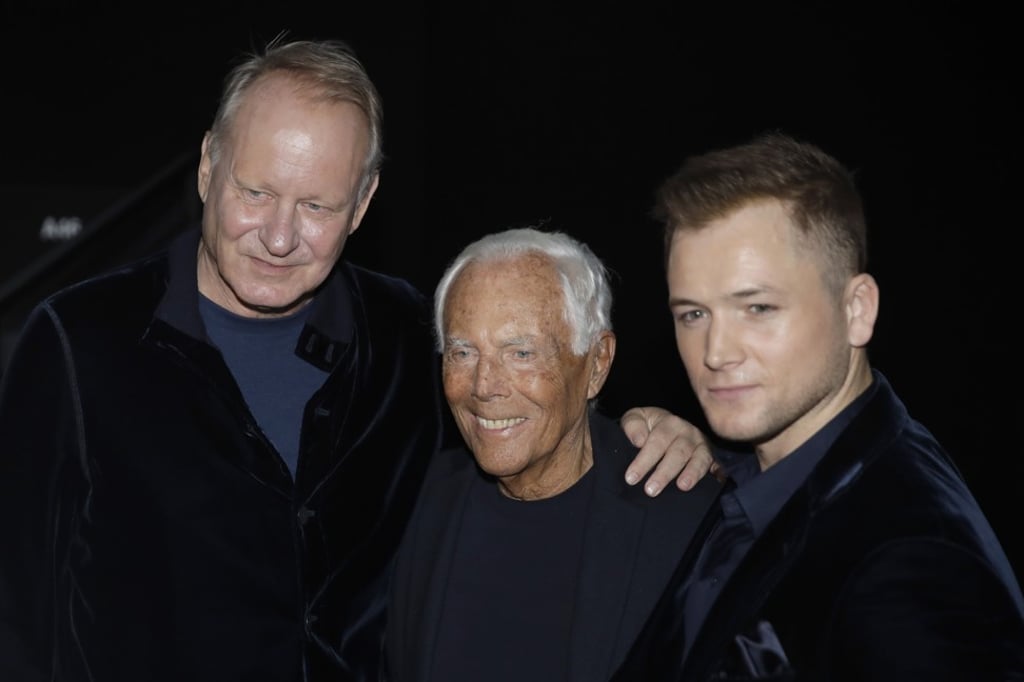 Designer Giorgio Armani, centre, poses with actor Taron Egerton, right, and actor Stellan Skarsgård after the Armani men’s Fall/Winter 2020-21 collection that was presented in Milan, Italy. Photo: Luca Bruno/AP Photo